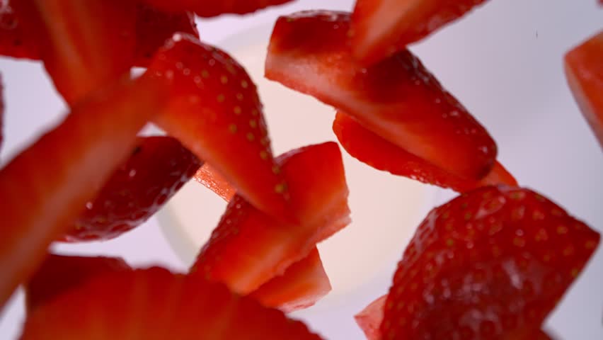 Super Slow Motion Shot of Fresh Strawberries Followed by Camera Falling into Milk at 1000fps.