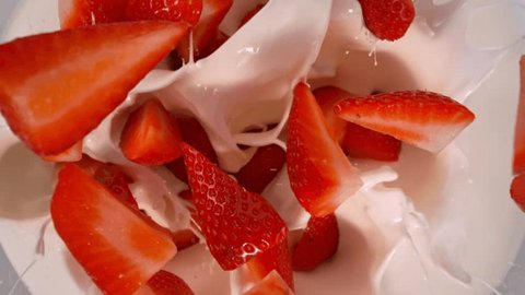 Super Slow Motion Shot of Fresh Strawberries Followed by Camera Falling into Milk at 1000fps. Stock-video