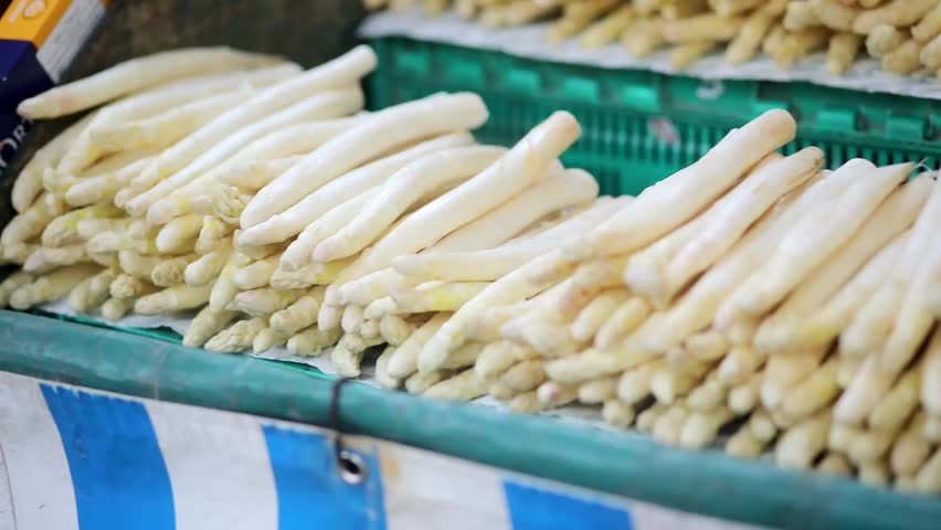 Fresh organic white asparagus on farmer market in Paris, France. Typical European market of home grown produce.