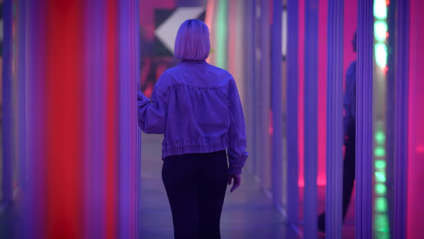 Confident Female Person Moving Inside Hall of Mirrors Seeing Self Reflection