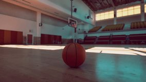 An old basketball lies on the hardwood floor of an empty gym, surrounded by echoes of past games and cheers. - Powered by Shutterstock - Get 15% off with code: PIKWIZARD15