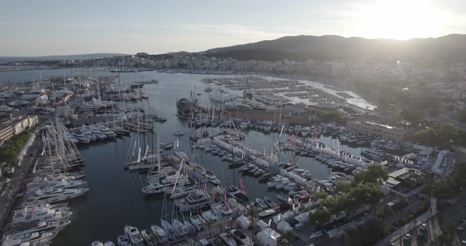 Aerial orbit harbor Palma de Mallorca with lots of docked sailing boats, sunset