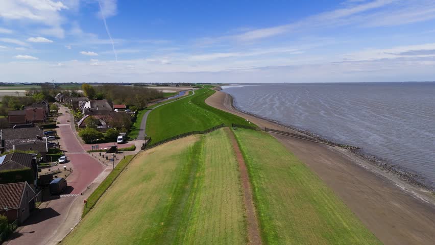 Aerial View: Dike with Grazing Sheep by the Waddenzee in Friesland, Netherlands