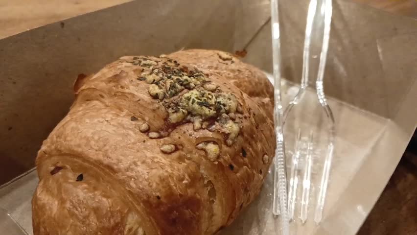 Close up of a croissant, a bakery product that is perfect for the breakfast menu every day. food box.