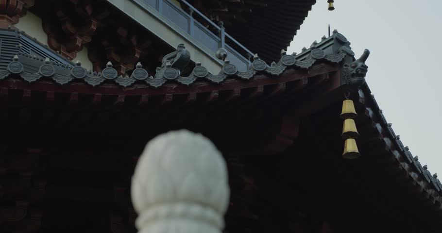 Sliding shot of a Chinese temple roof with Wind-bell in China. 4K