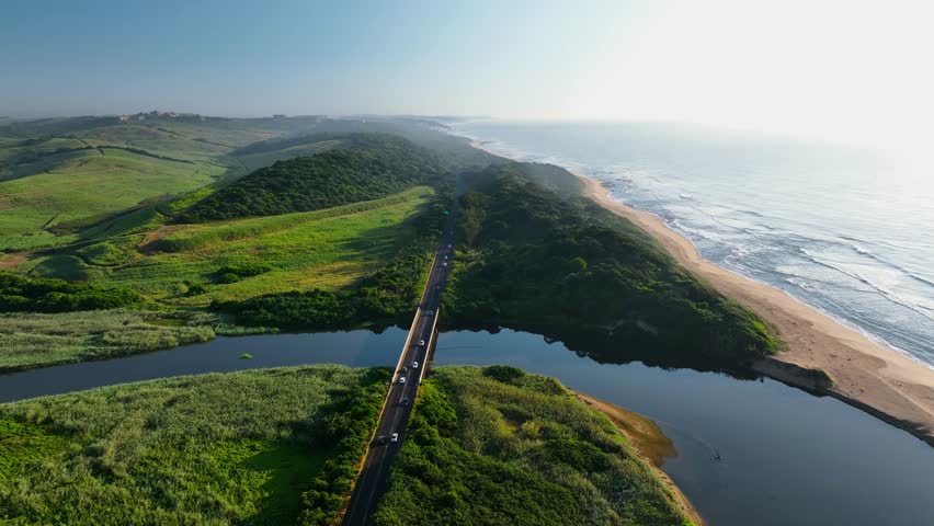 Aerial view of sandy beach and rolling waves along the coast, North Durban, South Africa.