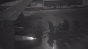 At dusk, airport staff load luggage onto the plane. A passenger plane is waiting for cargo to be loaded. High quality 4k footage - Powered by Shutterstock - Get 15% off with code: PIKWIZARD15