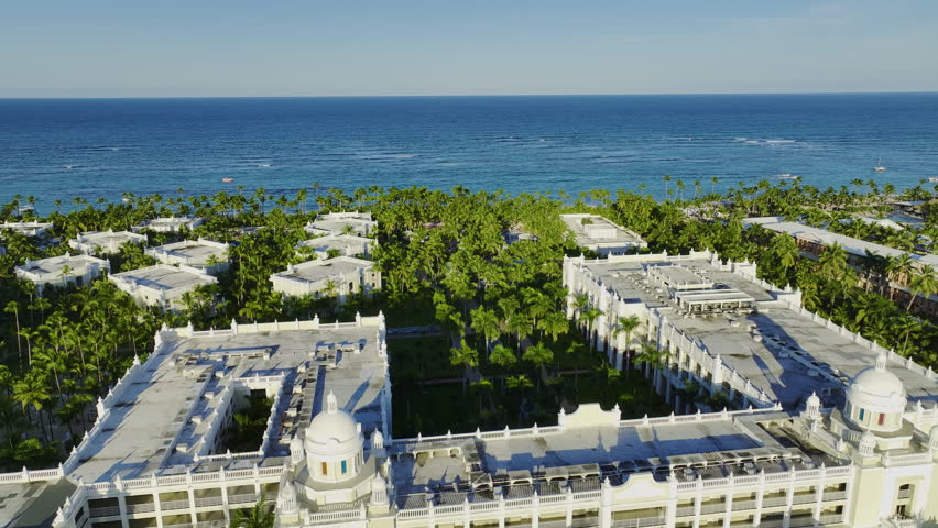Dense Palm Trees At Riu Palace Bavaro In Punta Cana, Dominican Republic. Aerial Pullback Shot