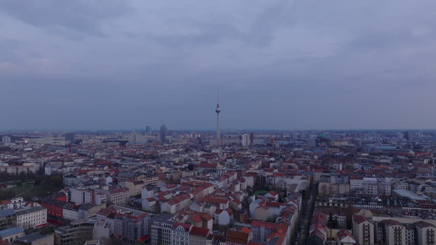Aerial view of Berlin's cityscape at dusk, capturing landmarks and architectural beauty from above against a serene twilight sky