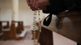 Woman Makes The Rosary Sitting Praying In Church For Peace - Powered by Shutterstock - Get 15% off with code: PIKWIZARD15