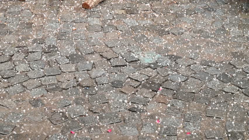 Hail storm in the city. Huge hailstone with heavy rainfall on the street. Thunderstorm. A lot of ice falling from clouds. 