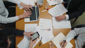 Top view of company reporting meeting. Accountants, financial analysts business workers team gathered for quarterly calculation of company's funds, analyze accounts. Command result, teamwork concept. - Powered by Shutterstock - Get 15% off with code: PIKWIZARD15