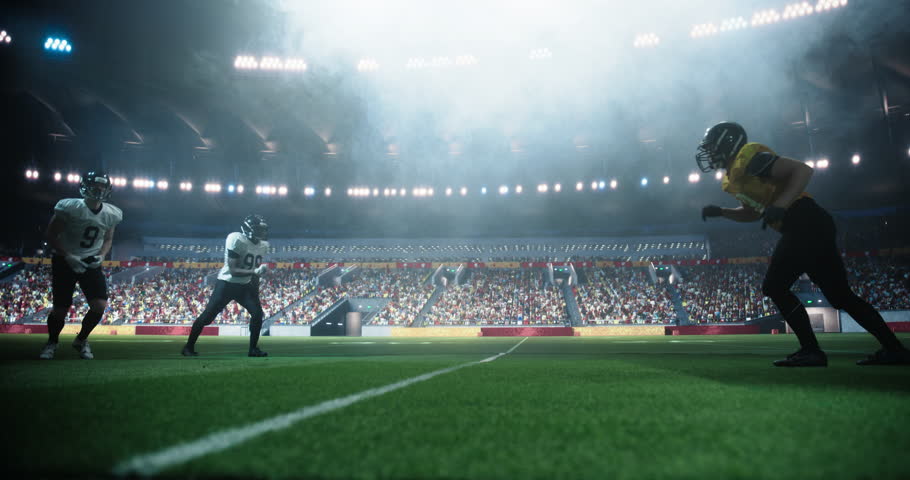 American Football Match in a Crowded Stadium: White Player Gets a Ball Pass and the Team is Fighting Its Way Forward to Reach the End Zone. Footballers Battle for Championship Victory