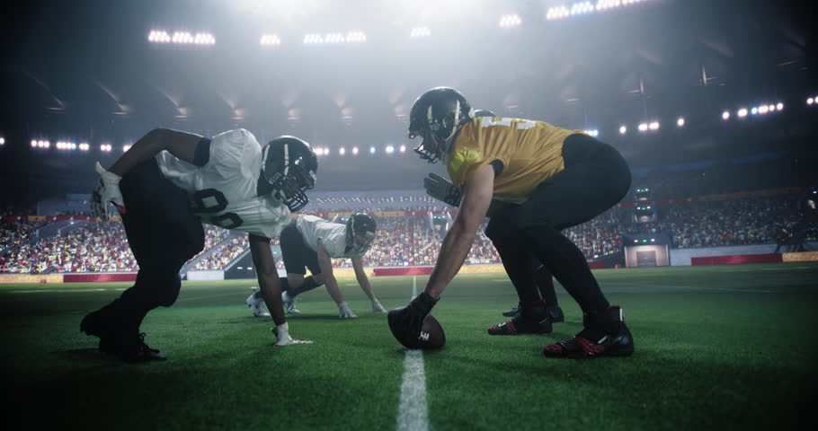 American Football Match with Players Face-off Before Action, Tackles, and Strategic Plays Start. Professional Male Footballers Fighting for the Ball, Playing a Dominant Offensive Game