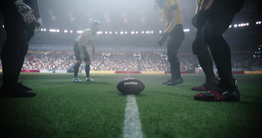 Gridiron Football Line of Scrimmage Standoff Between Two Diverse Teams Under Stadium Lights. Intense Moment of the Start of the Professional American Football Game, Players in Action During a Match