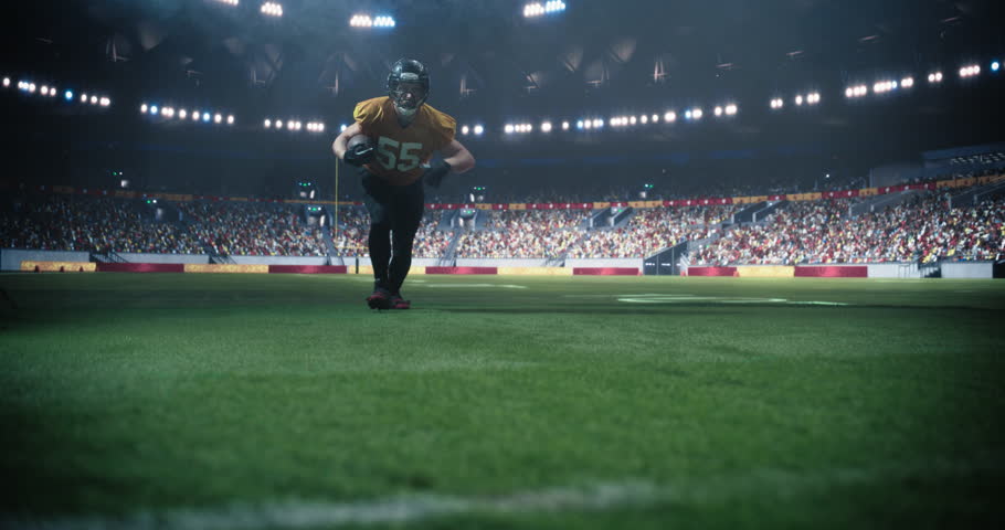 Portrait of a Powerful Footballer Running to Score a Goal, Jumping Over the End Zone to Make a Touchdown. Excited American Football Player Celebrating in Victorious Fashion, Flexing Muscles