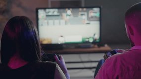 Brother and sister play nostalgic vintage arcade game. Rear shot of two young people playing retro game on tv screen. Coop mode for two gamers at home. Old style game on console - Powered by Shutterstock - Get 15% off with code: PIKWIZARD15