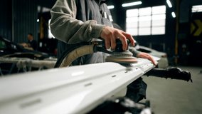 close up auto mechanic at a service station polishing the front part of white car - Powered by Shutterstock - Get 15% off with code: PIKWIZARD15