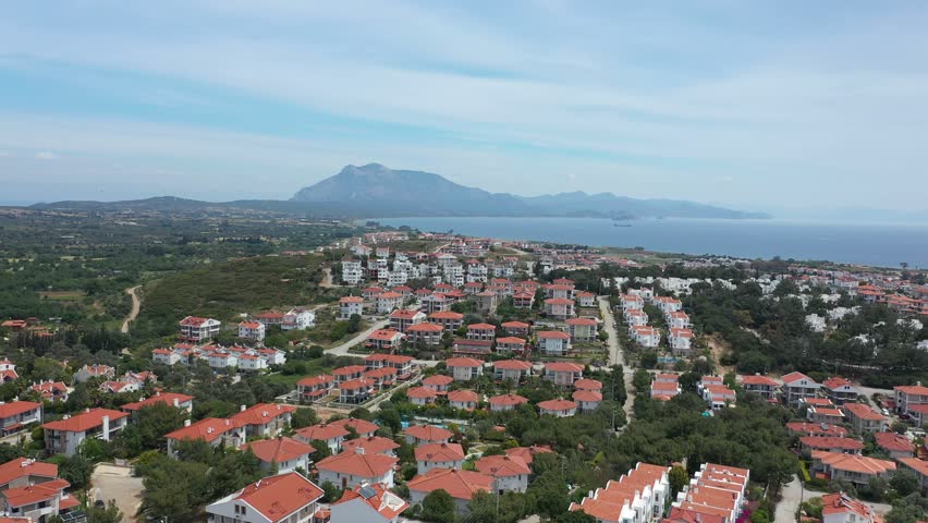 Bird eye view of Datcha city. Aerial view of Turkish city with cosy similar houses with red roofs