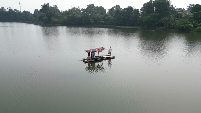 Fisherman checking fish trap nets in small lake