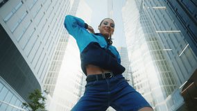 Handsome female dancer performing modern street dance in downtown. Creative young woman dancing near high-rise skyscrapers in city. Contemporary choreography, retro 80s urban style brunette girl - Powered by Shutterstock - Get 15% off with code: PIKWIZARD15
