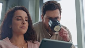 Morning pair looking tablet screen talking at grey apartment closeup. Positive lovers ordering food watching digital device display at panoramic hotel. Married couple discussing news at modern kitchen - Powered by Shutterstock - Get 15% off with code: PIKWIZARD15