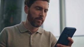 Man hands pouring coffee cup at large windows kitchen closeup. Focused businessman drinking espresso watching mobile phone. Serious bearded man taking coffee sip enjoying breakfast at luxury flat - Powered by Shutterstock - Get 15% off with code: PIKWIZARD15