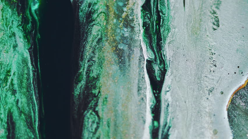 Ink drip. Glitter liquid spill. Blur black green blue golden color shiny glowing particles texture paint wave motion abstract art background.