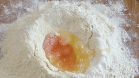 Egg splash on flour pile, close up. Slow motion footage.  - Powered by Shutterstock - Get 15% off with code: PIKWIZARD15