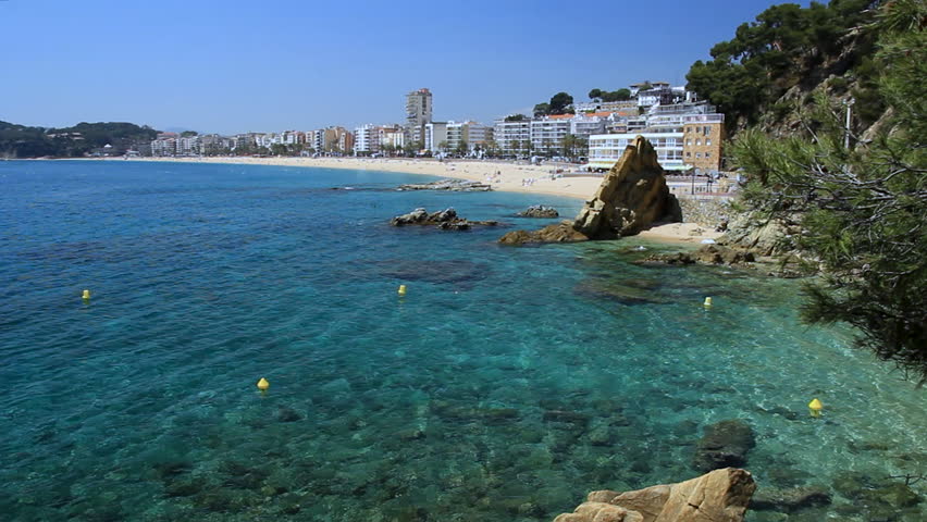 General view of the largest beach in Lloret de Mar from Sa Caleta cove. Costa Brava, Catalonia, Spain.