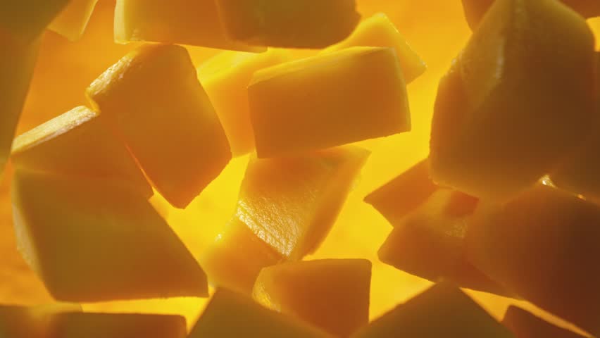 Super Slow Motion of Falling Mango Pieces into Water. Filmed on High Speed Cinema Camera, 1000fps, Placed on High Speed Cine Bot. Camera in Motion, Following Objects.