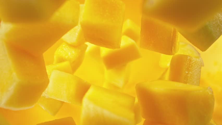 Super Slow Motion of Falling Mango Pieces into Water. Filmed on High Speed Cinema Camera, 1000fps, Placed on High Speed Cine Bot. Camera in Motion, Following Objects.