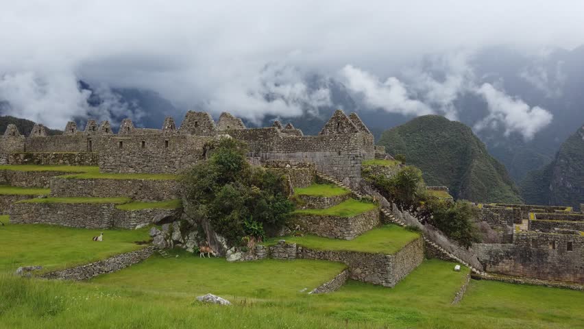 tracking shot left revealing Machu Picchu 15th-century Inca citadel