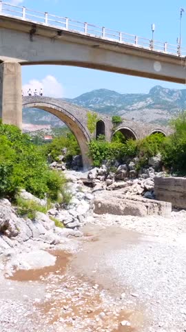 Aerial view of the Old Mes bridge near Shkoder from above. Albania, Europe. Ottoman stone arch bridge Ura e Kadiut