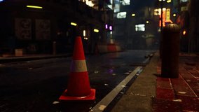 A bright neon traffic cone sits on the side of a road in a quiet Asian city during a rainy night. - Powered by Shutterstock - Get 15% off with code: PIKWIZARD15
