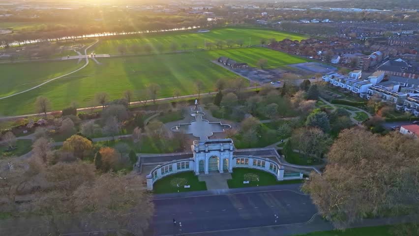 Main War Memorial in Nottingham captured from above on the sunset hours. Memorial gardens are neighbouring with Wilford Suspension Bridge also visible on the shot.