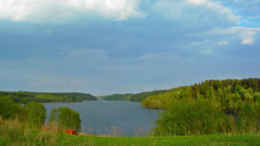 landscape with lake and clouds, tilt time-lapse