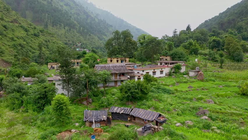 Aerial View of Village Encircled by Mountains and River