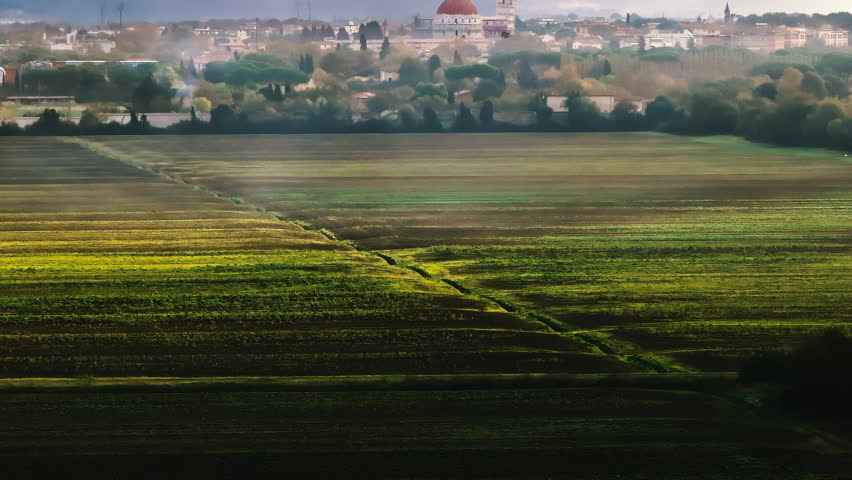 Pisa, Tuscany, Italy drone panorama during sunrise. Painting-like idyllic establishing shot in style of vedutismo. Piazza dei Miracoli with the Leaning Tower and the Baptistery view from a countryside