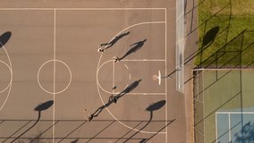 Top down view of a group of street basketball players playing hard on the court Canada, Dartmouth. Sport, leisure games and male friendship concept - group of men or friends playing street basketball  - Powered by Shutterstock - Get 15% off with code: PIKWIZARD15