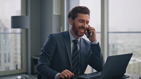 Smiling manager calling smartphone sitting cityscape office closeup. Happy confident businessman talking mobile phone gesturing hand at light workplace. Elegant boss consulting client at telephone  - Powered by Shutterstock - Get 15% off with code: PIKWIZARD15