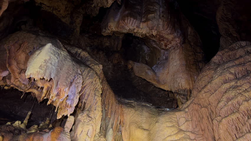  Beautiful view of stalactites and stalagmites in an underground cavern . High quality 4k footage