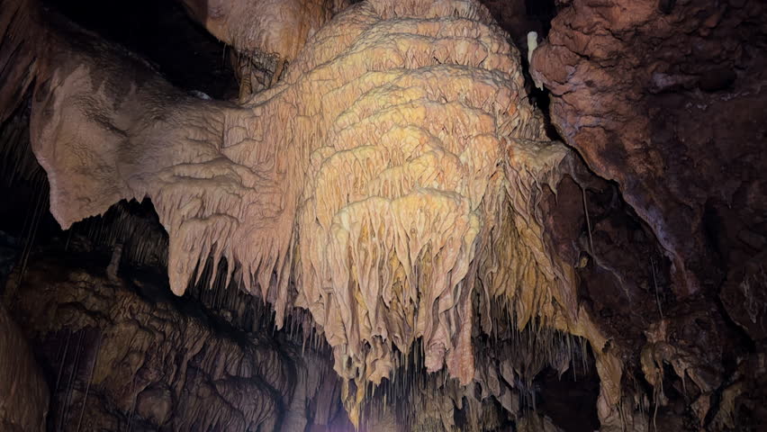  Beautiful view of stalactites and stalagmites in an underground cavern . High quality 4k footage