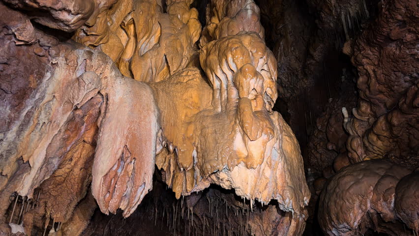  Beautiful view of stalactites and stalagmites in an underground cavern . High quality 4k footage