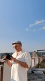 Man using vintage video camera on the city building rooftop