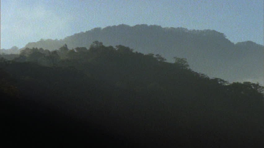 Timelapse of clouds moving over dark hills