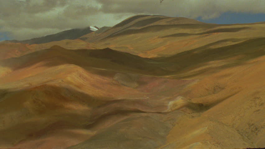 Timelapse of shadow of clouds over brown hills