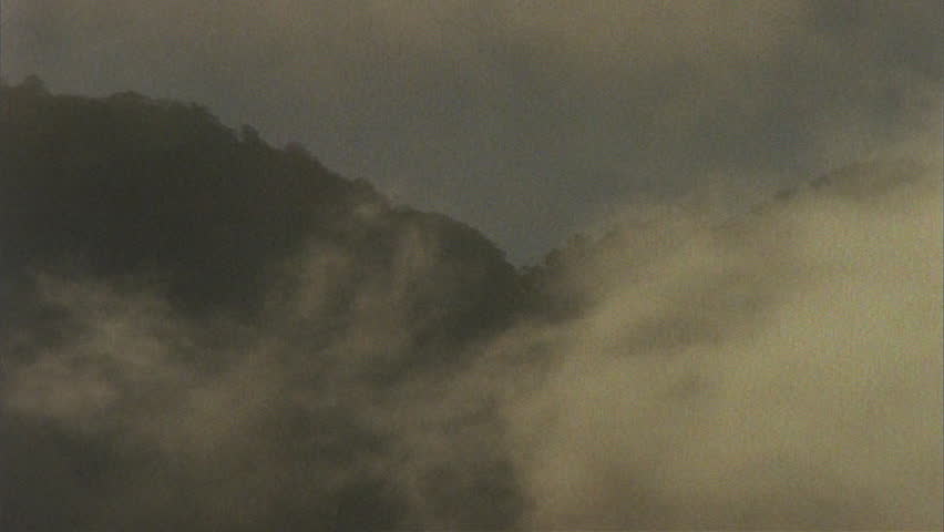 Timelapse of clouds moving over dark hills