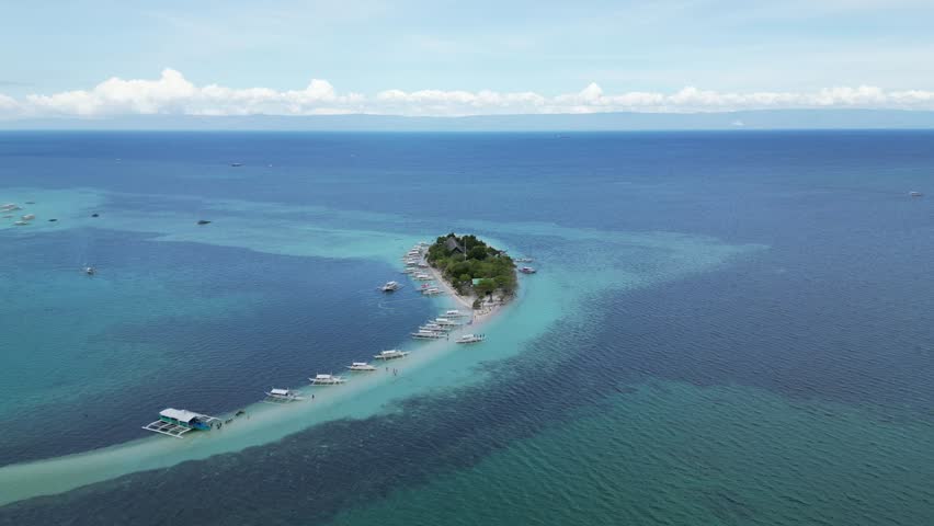 Aerial view of a beautiful Virgin Island, in Bohol, Philippines. White-sand beach and crystal-clear waters. Paradise.