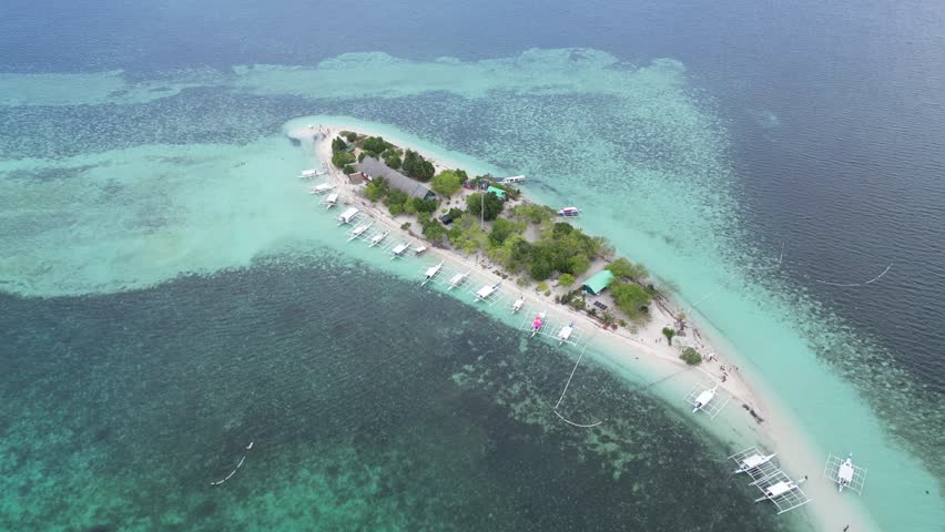 Aerial view of a beautiful Virgin Island, in Bohol, Philippines. White-sand beach and crystal-clear waters. Paradise.